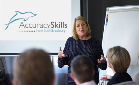 woman delivering training to group of people at desks